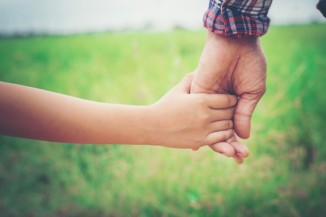 close-up-of-father-holding-his-daughter-hand-so-sweet-family-ti_1150-846